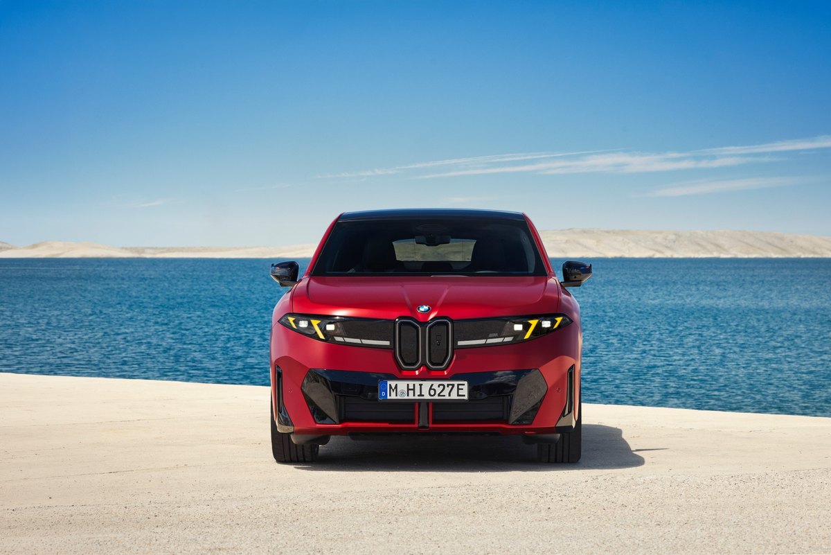 BMW iX4 M60 xDrive, elektryczne SUV coupé, widok z przodu nad brzegiem morza