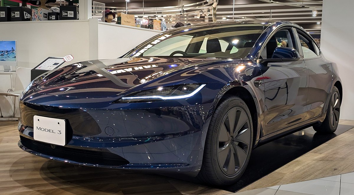 Tesla Model 3 w wersji Highland w granatowym lakierze, ujęcie z przodu w salonie