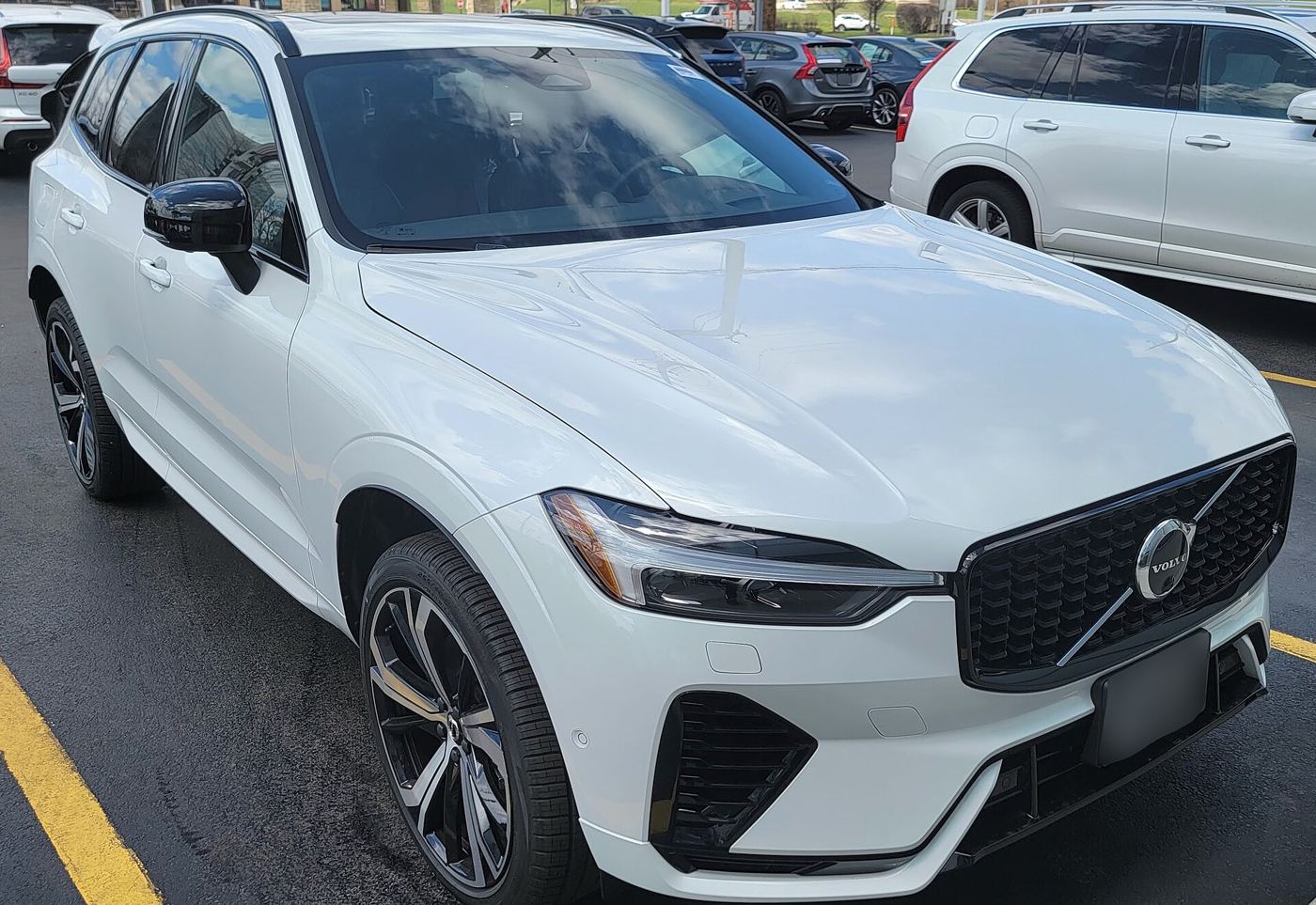 Biały Volvo XC60 T8, hybryda plug-in, zaparkowany na utwardzonym placu